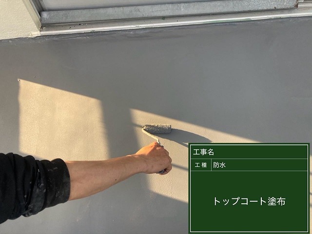 甲府市で屋上防水・ベランダ防水にトップコートを塗装する様子